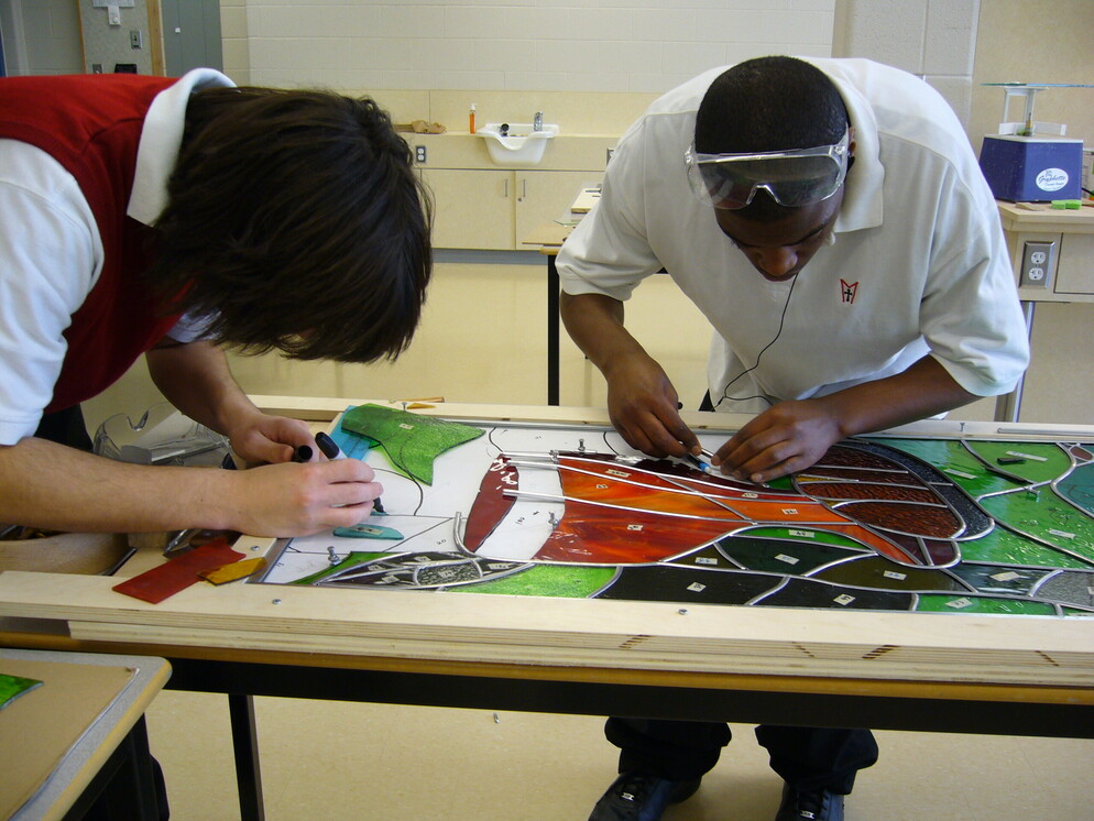 People tracing the glass patterns.